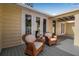 Cozy outdoor porch with wicker chairs and a view of the lovely backyard at 980 S Orange Ave, Sarasota, FL 34236