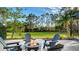 Backyard patio with an inviting fire pit and comfortable Adirondack chairs at 9818 Old Hyde Park Pl, Bradenton, FL 34202