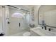 Well-lit bathroom featuring a glass enclosed shower and marble design at 9818 Old Hyde Park Pl, Bradenton, FL 34202
