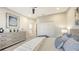 Charming bedroom with neutral tones, a dresser with modern accents, and an inviting bed at 9818 Old Hyde Park Pl, Bradenton, FL 34202