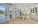 Bright dining room features modern lighting, wine rack, and natural light at 9818 Old Hyde Park Pl, Bradenton, FL 34202