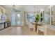 Elegant dining area featuring a glass table, modern chairs, and decorative mirrors at 9818 Old Hyde Park Pl, Bradenton, FL 34202