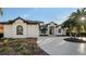 Well-maintained front exterior with lush landscaping and beautiful architectural details at 9818 Old Hyde Park Pl, Bradenton, FL 34202