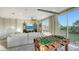 Game room with comfortable sectional sofa, foosball table, entertainment center, and scenic outdoor views at 9818 Old Hyde Park Pl, Bradenton, FL 34202