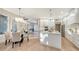 Open concept featuring a white kitchen with a large island adjacent to a dining and living area at 9818 Old Hyde Park Pl, Bradenton, FL 34202