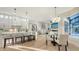 Bright kitchen with white cabinets, a large center island, and modern pendant lighting at 9818 Old Hyde Park Pl, Bradenton, FL 34202