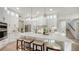 White kitchen featuring a large island with seating, stainless steel appliances, and sleek design at 9818 Old Hyde Park Pl, Bradenton, FL 34202