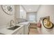 Well-lit laundry room boasts modern appliances, ample cabinet space, and a convenient utility sink at 9818 Old Hyde Park Pl, Bradenton, FL 34202