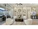 Bright living room featuring a fireplace, decorative mirror, and four cozy chairs at 9818 Old Hyde Park Pl, Bradenton, FL 34202