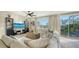 Bright living room boasts a large sectional couch, modern entertainment center, and scenic outdoor views at 9818 Old Hyde Park Pl, Bradenton, FL 34202