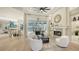 Open-concept living room with fireplace, comfortable seating, and view to a pool at 9818 Old Hyde Park Pl, Bradenton, FL 34202