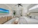 Bright main bedroom featuring a seating area, TV, ceiling fan, and ample natural light at 9818 Old Hyde Park Pl, Bradenton, FL 34202