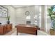 Home office with a modern desk, stylish chair, and decorative shelving at 9818 Old Hyde Park Pl, Bradenton, FL 34202