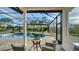 Relaxing screened-in pool area with spa, sun umbrellas, and a tranquil view at 9818 Old Hyde Park Pl, Bradenton, FL 34202