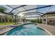 Sparkling pool and hot tub surrounded by an outdoor living space and lush greenery at 9818 Old Hyde Park Pl, Bradenton, FL 34202