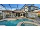 Stunning outdoor pool area with a screened enclosure and manicured landscaping at 9818 Old Hyde Park Pl, Bradenton, FL 34202