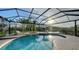 Inviting screened-in pool and spa area with lounge chairs and a serene lake view at 9818 Old Hyde Park Pl, Bradenton, FL 34202