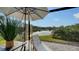 Enjoy stunning lake views from this patio with an umbrella and a lounge chair at 9818 Old Hyde Park Pl, Bradenton, FL 34202