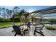 Outdoor oasis featuring a pool, spa, patio, and a cozy fire pit area at 9818 Old Hyde Park Pl, Bradenton, FL 34202