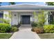 Inviting home entrance featuring lush landscaping and double front doors at 5111 Canterbury Dr, Sarasota, FL 34243