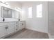 Bright bathroom featuring double vanity, two windows, and modern fixtures at 10 Mast Dr # 1, Placida, FL 33946