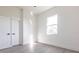 Bright bedroom featuring gray wood floors and two doors at 10 Mast Dr # 1, Placida, FL 33946