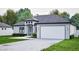 Single-story home with a two-car garage, modern architectural details, and landscaped front yard at 10 Mast Dr # 1, Placida, FL 33946