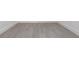 Close-up of gray wood-look vinyl plank flooring and white baseboards at 10 Mast Dr # 1, Placida, FL 33946