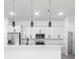 Modern kitchen with stainless steel appliances, white cabinets, and pendant lighting at 10 Mast Dr # 1, Placida, FL 33946
