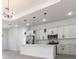 Bright, modern kitchen with stainless steel appliances, white cabinets, and an island with pendant lighting at 10 Mast Dr # 1, Placida, FL 33946
