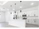 Open kitchen featuring stainless steel appliances, white cabinets, and a kitchen island at 10 Mast Dr # 1, Placida, FL 33946