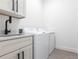 Bright laundry room area with sink and storage. Washer and dryer included at 10 Mast Dr # 1, Placida, FL 33946