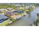Stunning aerial view of waterfront homes with private docks and lush landscaping in a serene neighborhood at 10494 Atenia St, Port Charlotte, FL 33981