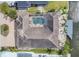 Aerial view showcasing a property with a screened pool and canal access at 10494 Atenia St, Port Charlotte, FL 33981