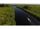 Aerial shot of sailboat gliding through waterway with green landscape at 10494 Atenia St, Port Charlotte, FL 33981