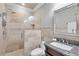 Elegant bathroom with a tiled shower, glass door, and a granite countertop sink at 10494 Atenia St, Port Charlotte, FL 33981