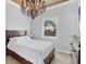 Bright bedroom featuring a chandelier and a large window with outdoor views at 10494 Atenia St, Port Charlotte, FL 33981