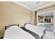 Bedroom with two twin beds and sliding glass doors that opens to the screened-in pool and patio at 10494 Atenia St, Port Charlotte, FL 33981
