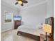 A calm, bright bedroom with tiled floor, neutral walls, and a comfortable bed at 10494 Atenia St, Port Charlotte, FL 33981