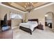 Spacious main bedroom with a chandelier and easy access to the ensuite bathroom and closet at 10494 Atenia St, Port Charlotte, FL 33981