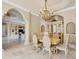 View of the dining room with adjacent columns and view into the open-concept living area at 10494 Atenia St, Port Charlotte, FL 33981