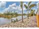 Lush waterfront view of a private boat dock bordered by greenery at 10494 Atenia St, Port Charlotte, FL 33981