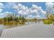 View of a modern dock with wooden pilings on a tranquil waterfront at 10494 Atenia St, Port Charlotte, FL 33981