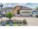 Lovely home featuring a beautiful stone front, an arched entryway, and lush landscaping at 10494 Atenia St, Port Charlotte, FL 33981