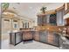 Bright and modern kitchen featuring granite countertops, stainless steel appliances, and ample storage at 10494 Atenia St, Port Charlotte, FL 33981