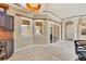 Open kitchen and dining area featuring bright marble floors, custom cabinets, and a view of the outdoor patio at 10494 Atenia St, Port Charlotte, FL 33981