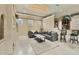 Open-concept living area features modern seating and lighting, plus a bar area for added convenience at 10494 Atenia St, Port Charlotte, FL 33981