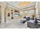 Open-concept living area featuring a modern built-in entertainment center, marble flooring, and custom lighting at 10494 Atenia St, Port Charlotte, FL 33981
