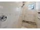 Beautifully tiled shower with a built-in bench and modern shower head at 10494 Atenia St, Port Charlotte, FL 33981
