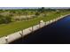 Aerial waterfront view with walking pier, a waterway and nearby park and recreation areas at 10494 Atenia St, Port Charlotte, FL 33981